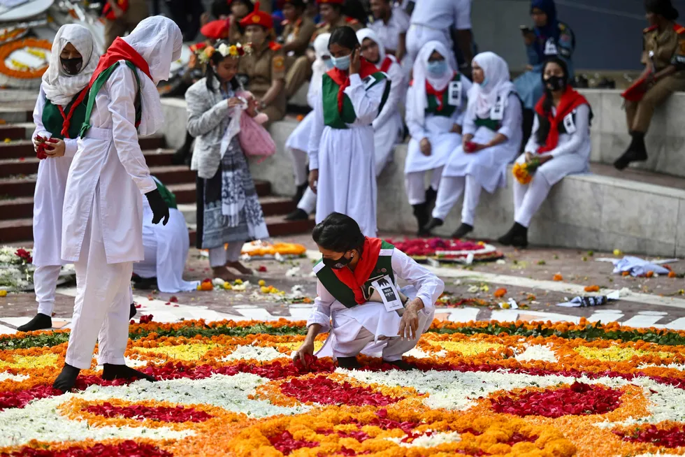 Dhaka: volunteers decorate with flowers petals a display at the Bangladesh Central Language Martyrs' Memorial monument in homage to the martyrs of the 1952 Bengali language movement