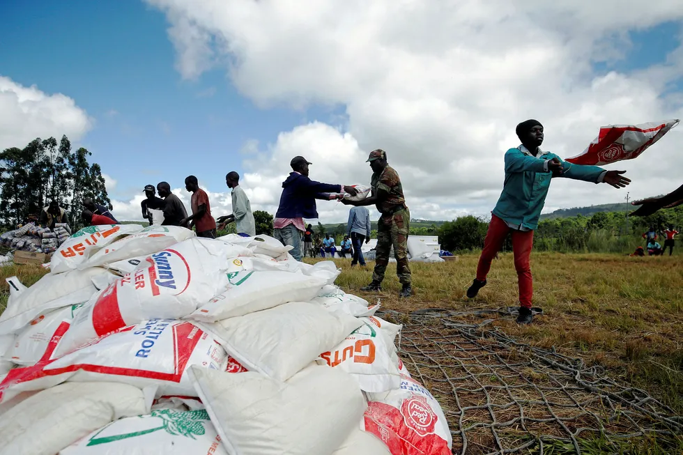 Aid workers offload maize meal for victims of Cyclone Idai at Siverstream Estates in Chipinge, Zimbabwe