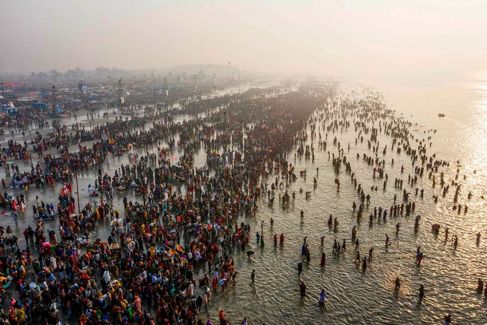 TOPSHOT – In this aerial photo taken on January 14, 2020, Hindu devoteks gather to take a holy dipp in the Bay of Bengal during the Gangasagar Mela, at Sagar Island, some 150 kilometers south of Kolkata. (Photo by XAVIER GALIANA / AFP) ---