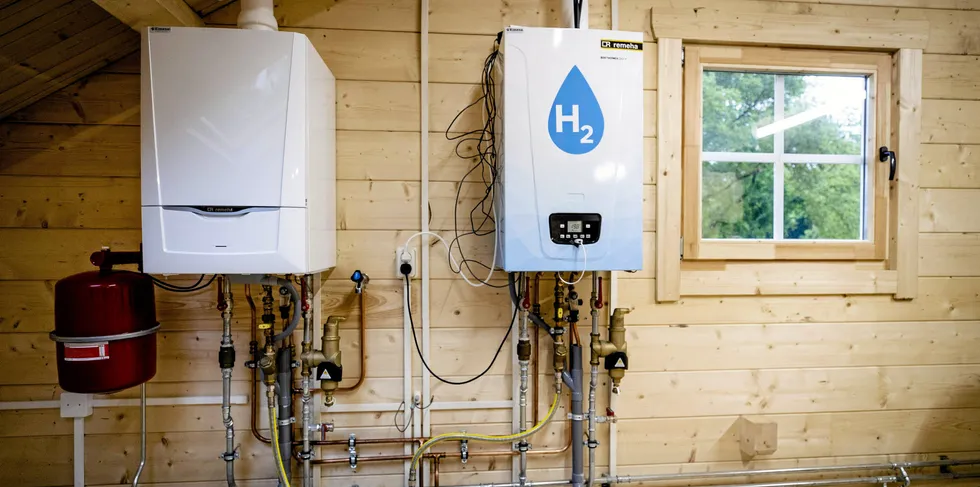 An old central heating boiler and a hydrogen boiler inside the Hydrogen Experience Centre, a training location for technicians, in the Netherlands.
