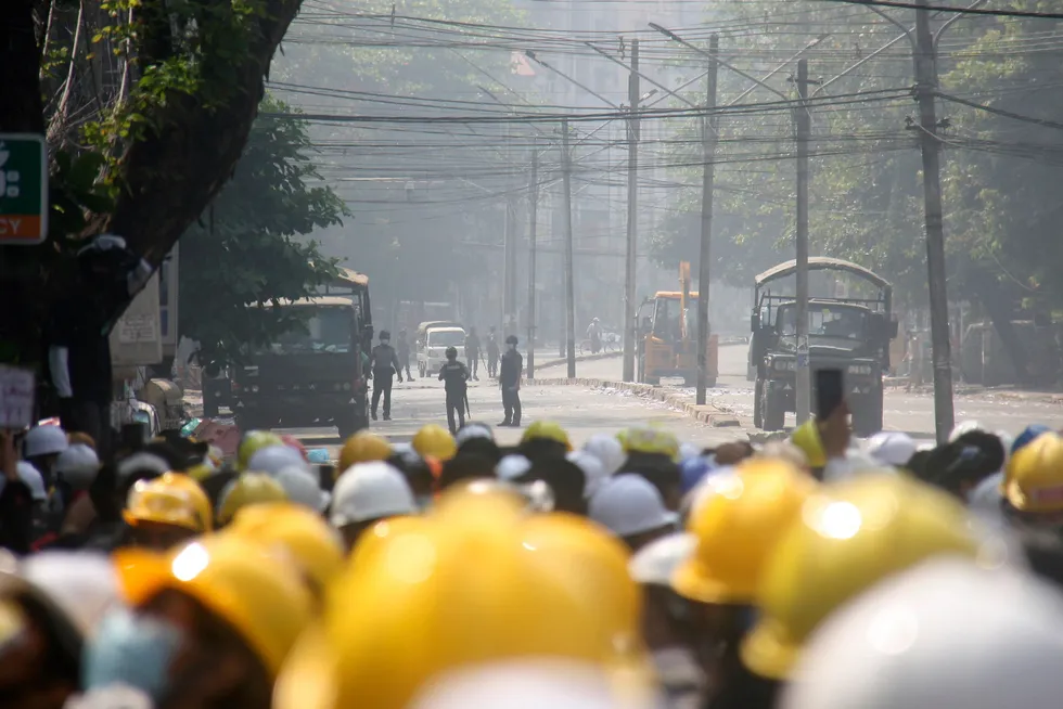 Clashes: protesters monitor police movement during an anti-coup protest on a blocked road in Mandalay, Myanmar on 2 March
