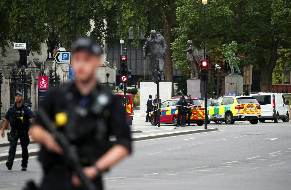 Bevæpnet politi på gaten utenfor det britiske parlamentet i London etter at en bil krasjet inn i sikkerhetssperringer.