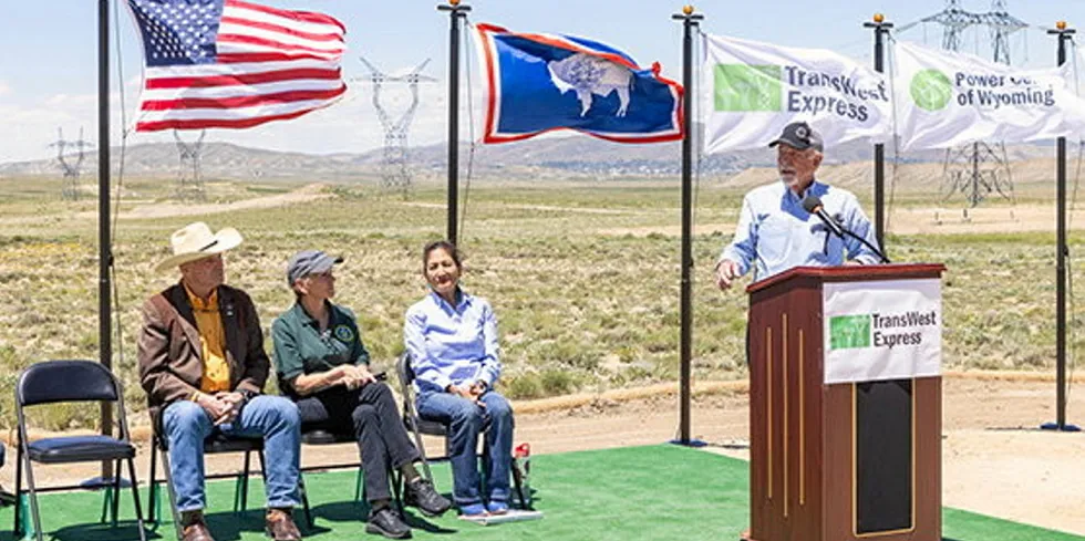 Bill Miller, chief executive of Chokecherry and Sierra Madre 9CCSM) and sister project TransWest Express, speaks last June at ceremonial groundbreaking of transmission project in Wyoming. Listening (l-to-r) are Governor Mark Gordon, Energy Secretary Jennifer Granholm, and Interior Secretary Deb Haaland.