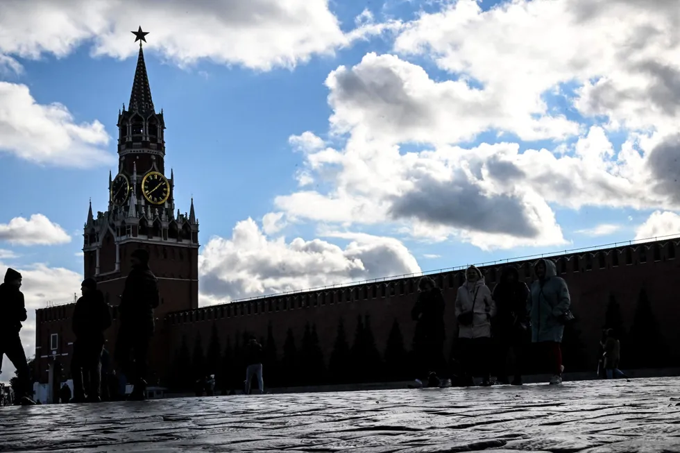 Afraid of the shadow: People walk along Red Square next to the Kremlin in Moscow.