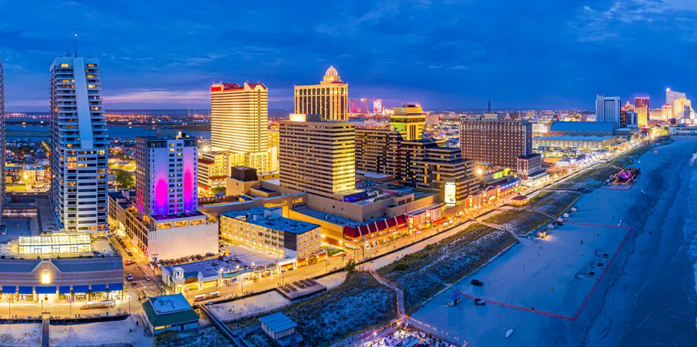 Aerial panorama of Atlantic City, New Jersey, along the boardwalk at dusk.