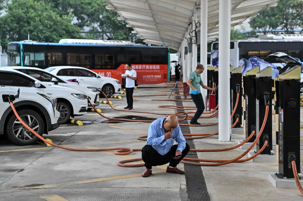 Drivers wait for their electric vehicles to charge at Antuoshan charging station in Shenzhen, China, in 2023. Sinopec Group's president said Wednesday in Houston that China's refined products output will fall as a result of fast-growing EV sales.