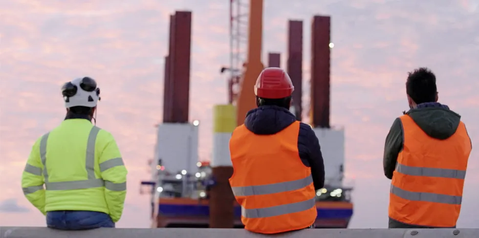 Workers contemplate Italy's pioneering Beolica offshore wind project.
