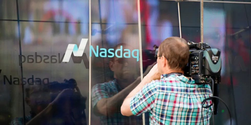A TV cameraman shoots through the windows of the Nasdaq offices in Times Square.