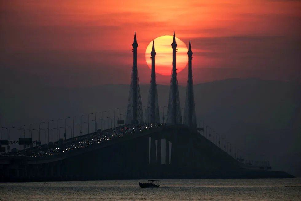 Opportunities: sun rises over the Penang bridge in Penang island, northern Malaysia