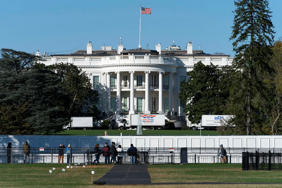 People look at the South Lawn of the White House the day before the 2020 US presidential election.