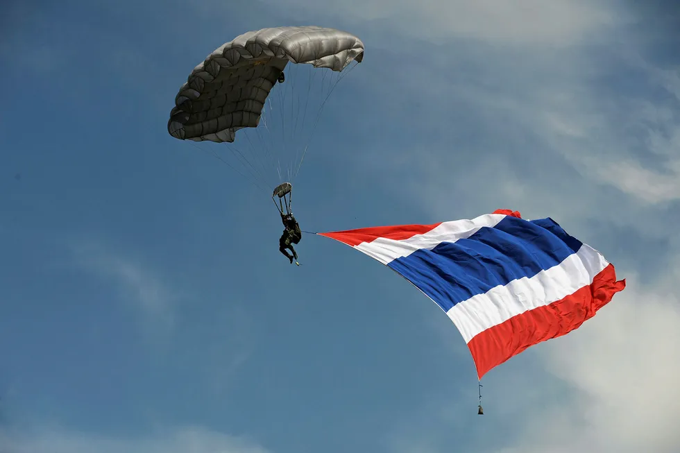Flying the flag: a Thai soldier parachutes with the national flag during a military exercise