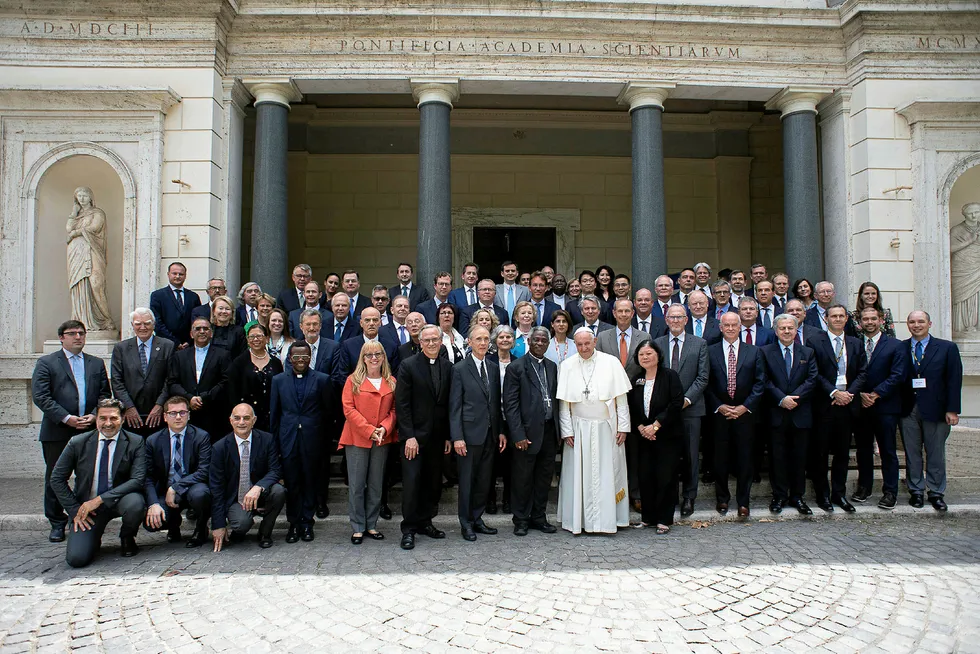 Pope Francis poses for a photograph with energy representatives at the end of a two-day meeting at the Academy of Sciences, at the Vatican