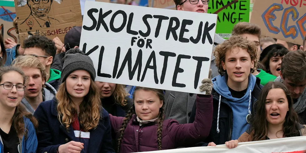 German student leader Luisa Neubauer next to Swedish climate activist Greta Thunberg (with banner) at protest