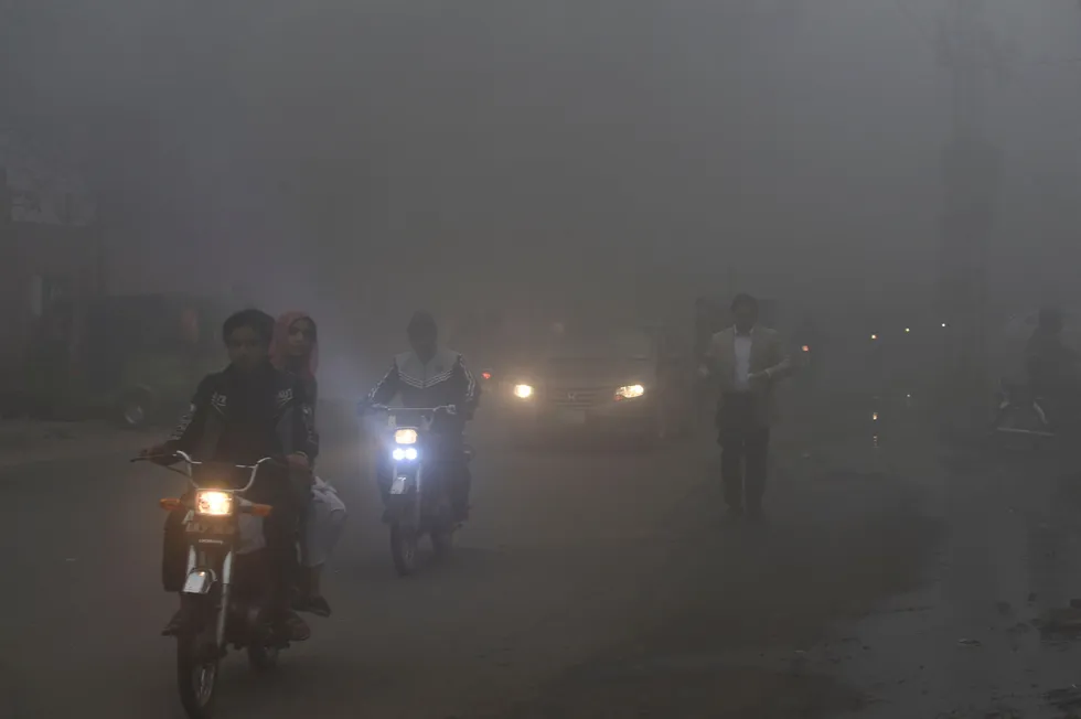 Smog: commuters make their way along a street amid heavy smog conditions experienced in Lahore, Pakistan, in February 2021