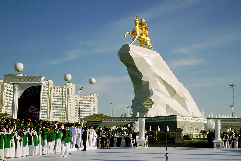 Terms: a monument topped by a statue of President Gurbanguly Berdymukhamedov in Ashgabat, Turkmenistan