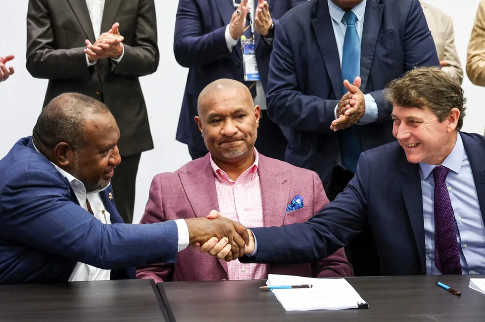 Papua New Guinea's Prime Minister James Marape (left) shakes hands with Twinza executive chairman Stephen Quantrill at the Pasca Gas Agreement signing in Sydney on 10 December 2024.