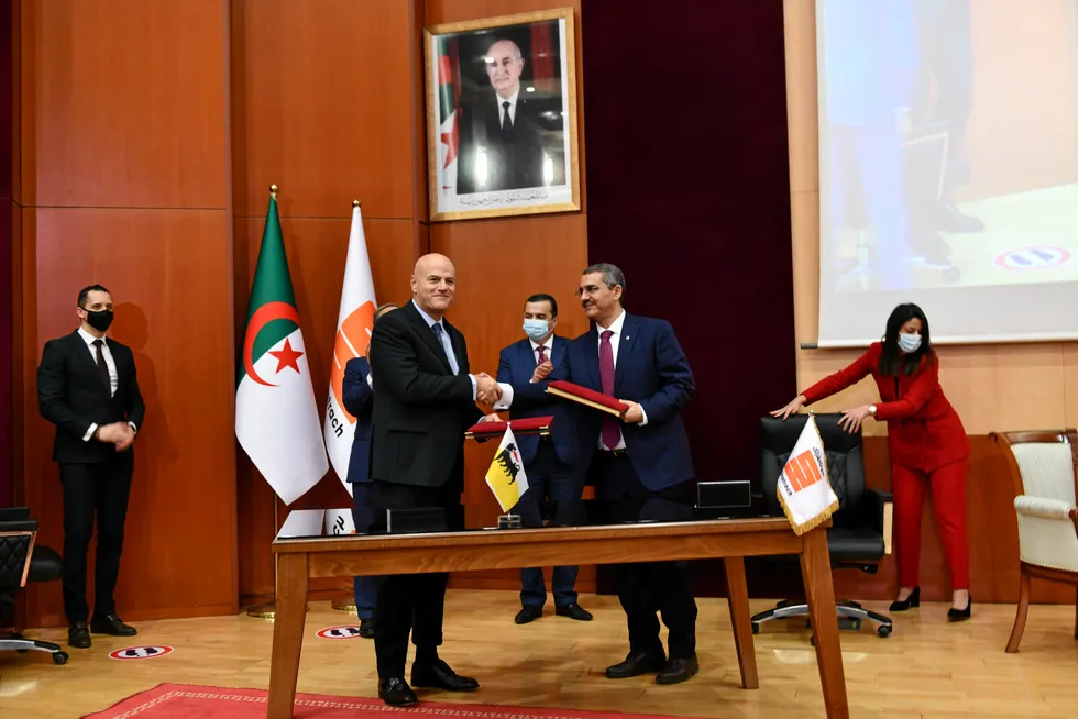 Shake on it: Eni chief executive Claudio Descalzi (centre-left) and Sonatrach chief executive after signing oil and transition agreements in Algiers on 14 December