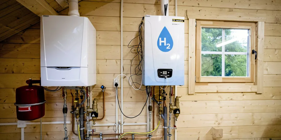 An old central heating boiler (L) and a hydrogen boiler inside the Hydrogen Experience Centre in Apeldoorn, Netherlands, the hydrogen house of certification body Kiwa and Dutch gas, heat and power distributor Alliander