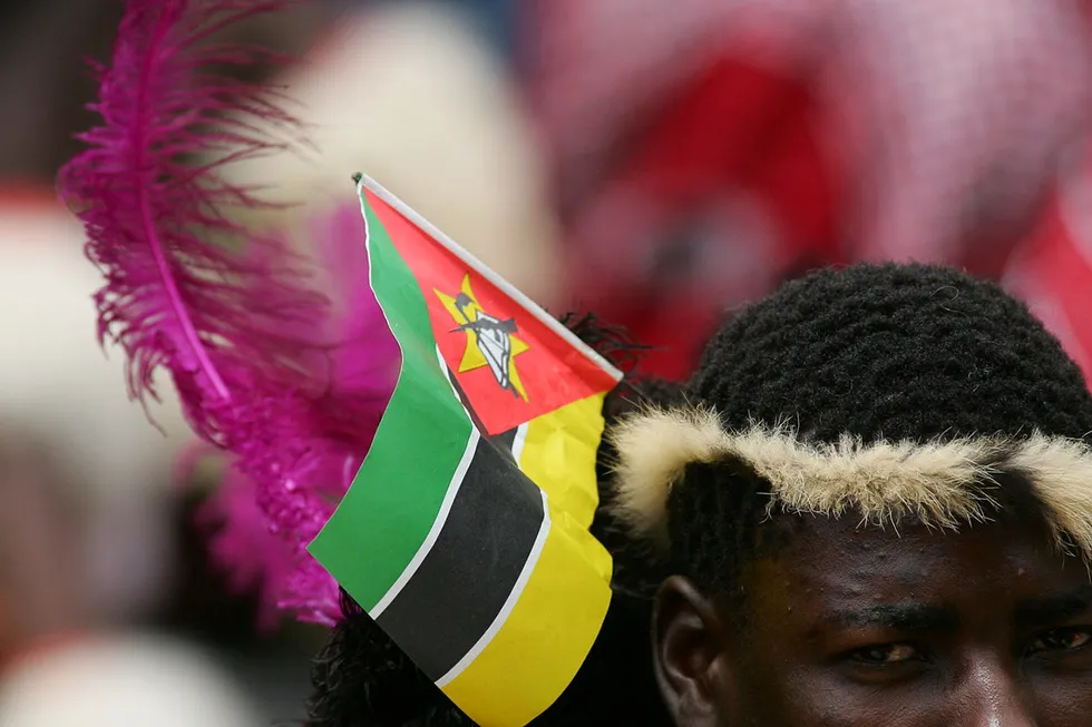 Focused: a South African wearing the Mozambican flag at a commemoration service to remember the country's former president Samora Machel who died in a plane crash in 1986