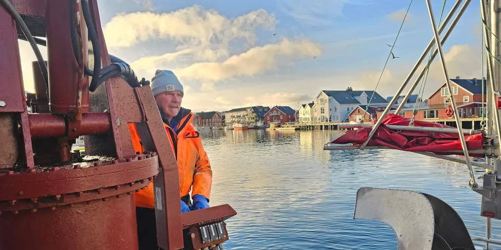 Holger Rune Pedersen styrer krana mens sønnen Patrick Pedersen fester kassene med fisk fra lasterommet.