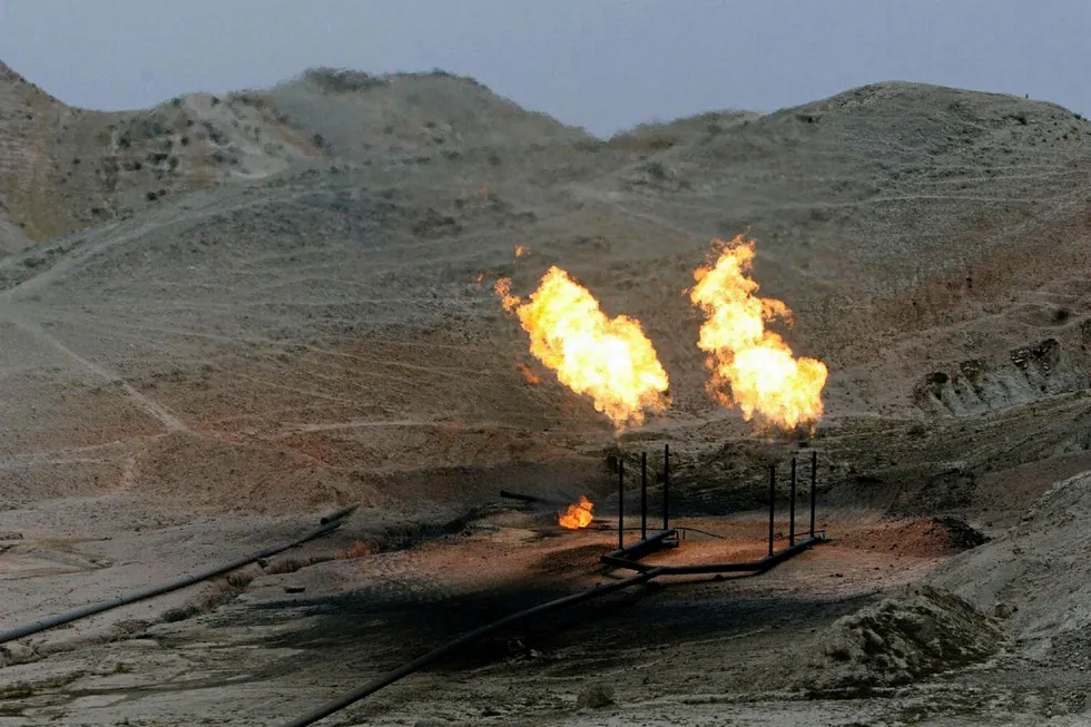 Gas flares burn near an oil well in Khuzestan province