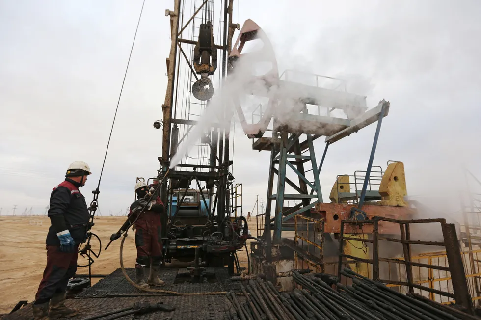 Pressure relief: workers use a steam jet to clean an oil pump at a well on the Ozen oilfield.