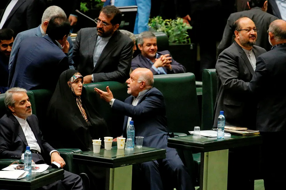 Vote of confidence: Iran's Oil Minister Bijan Zanganeh (bottom right) speaks with parliament members in Tehran