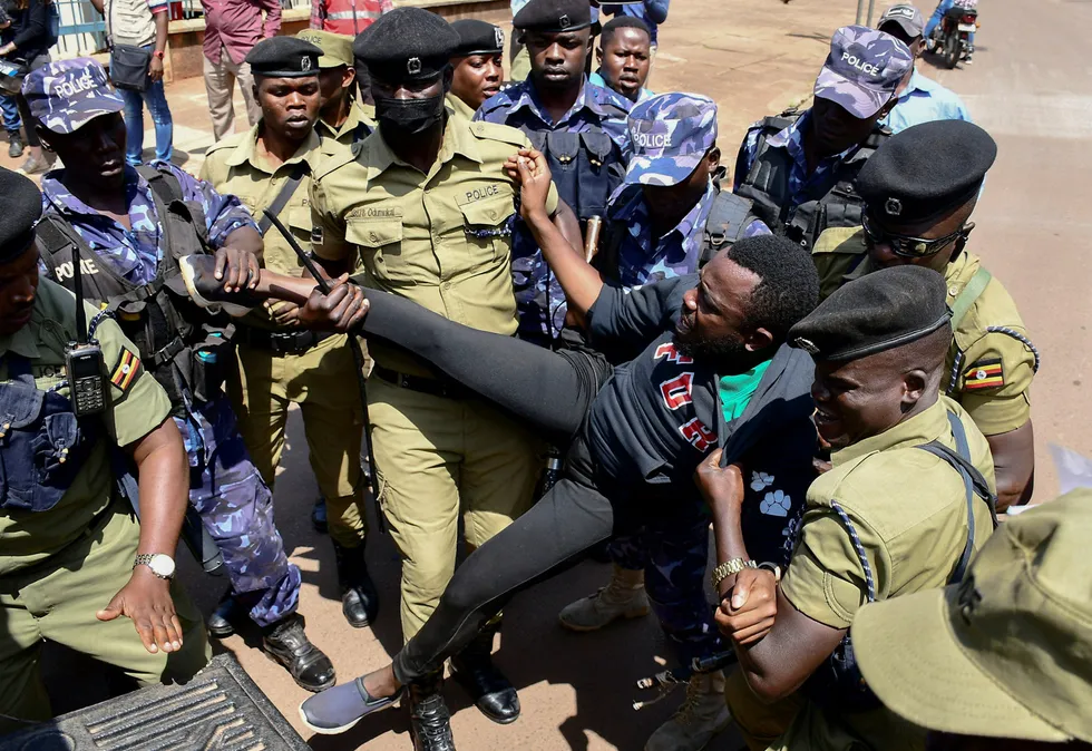 Arrest: Ugandan riot police officers detain an activist during a march near the European Union offices in Kampala.