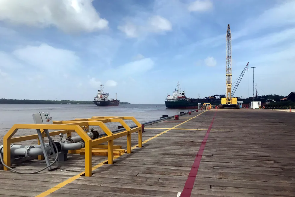 Big business: vessels carrying offshore supplies for ExxonMobil at the Guyana Shore Base wharf on the Demerara River in Guyana