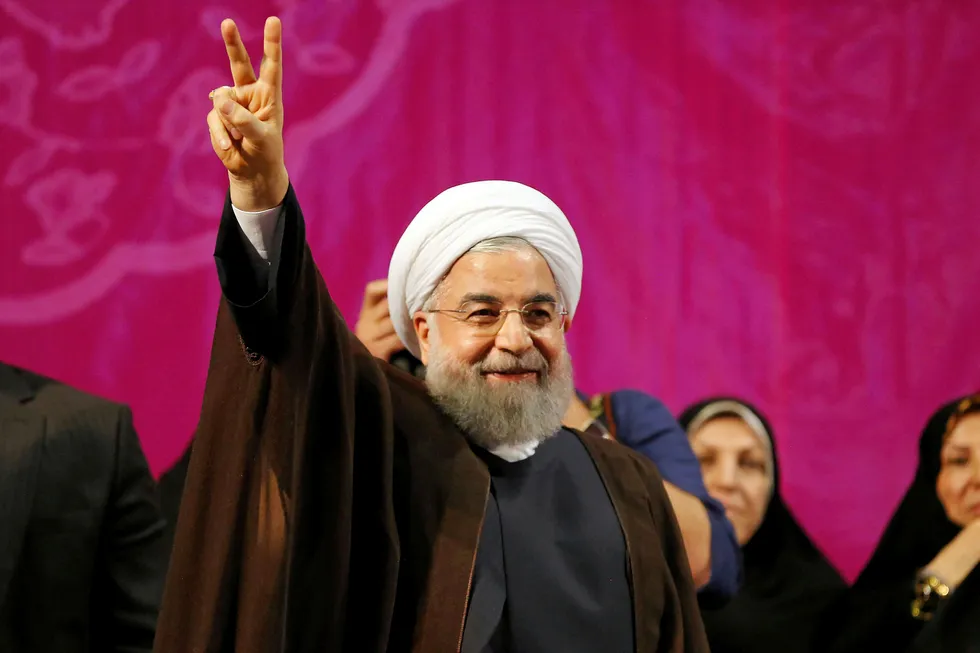Favourite: Iranian President and presidential candidate Hassan Rouhani gestures during a campaign rally in Tehran