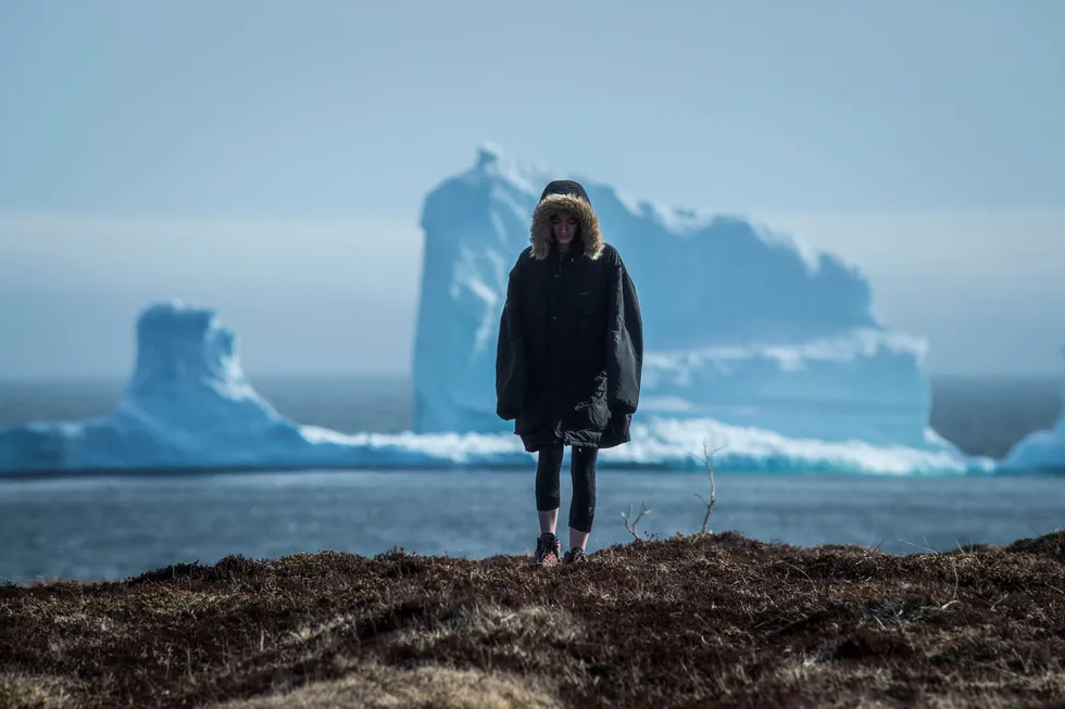 Bleak outlook: a resident walks away from an iceberg offshore Newfoundland, Canada.