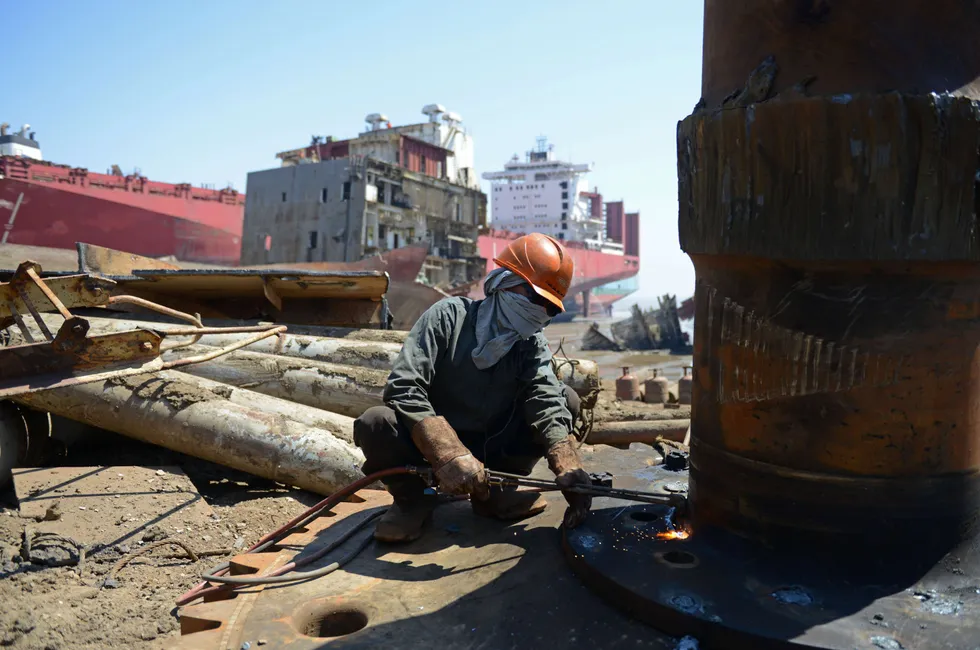 A shipbreaker at work at a yard in India.
