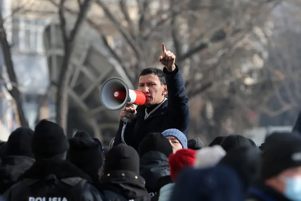 No change: a protester speaks through a megaphone during a rally held by opposition supporters on the parliamentary election day in Kazakhstan's second-largest city of Almaty on 10 January 2021