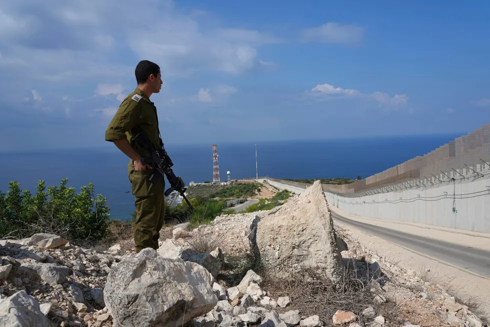 Agreement: Looking out to sea, an Israeli soldier stands near the fence on the Israeli onshore border with Lebanon in Ras Hanikra. The two nations have just finalised a maritime boundary deal