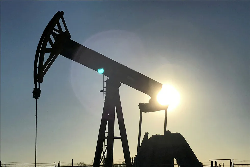 Parsley: An oil rig drilling a well at sunrise near Midland, Texas