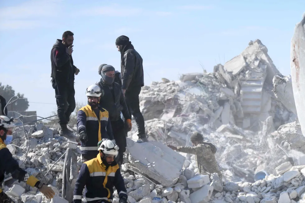 Rescue workers remove a gas bottles from the rubble of a building after an earthquake hit Turkey and Syria.
