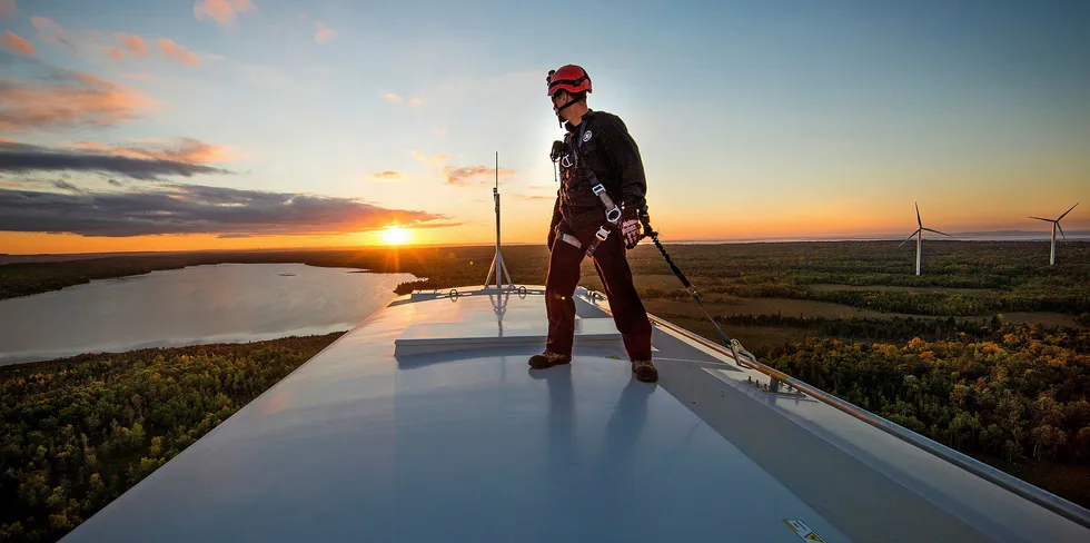 Technician atop GE Renewable turbine