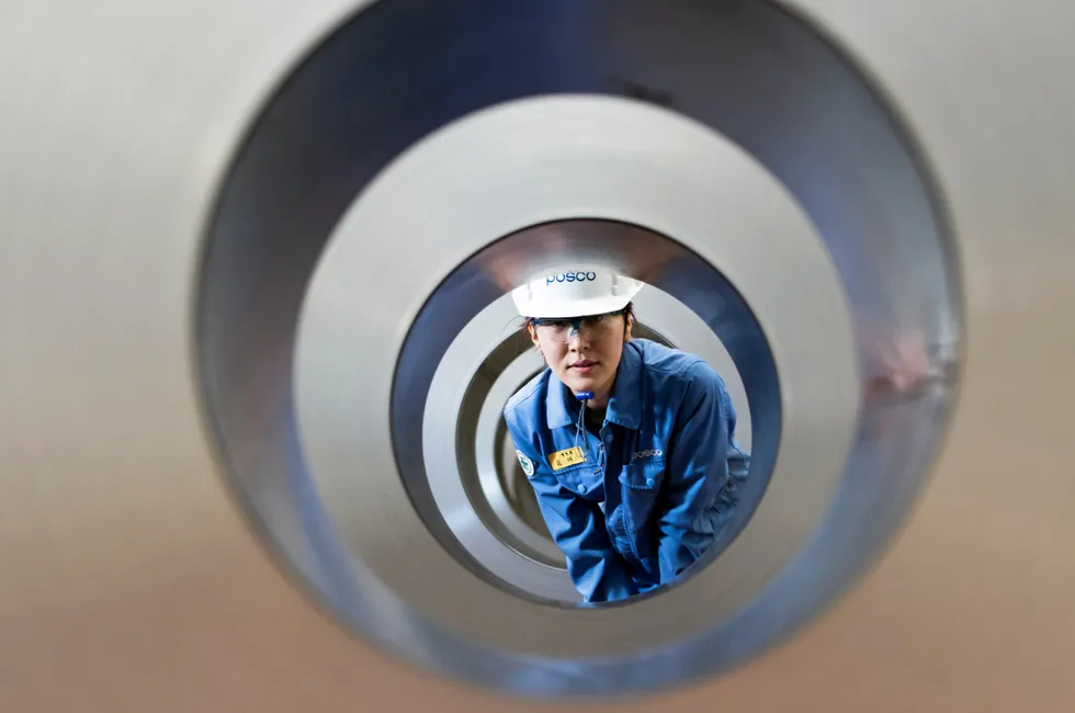 A Posco engineer looks through rolls of rolled steel.