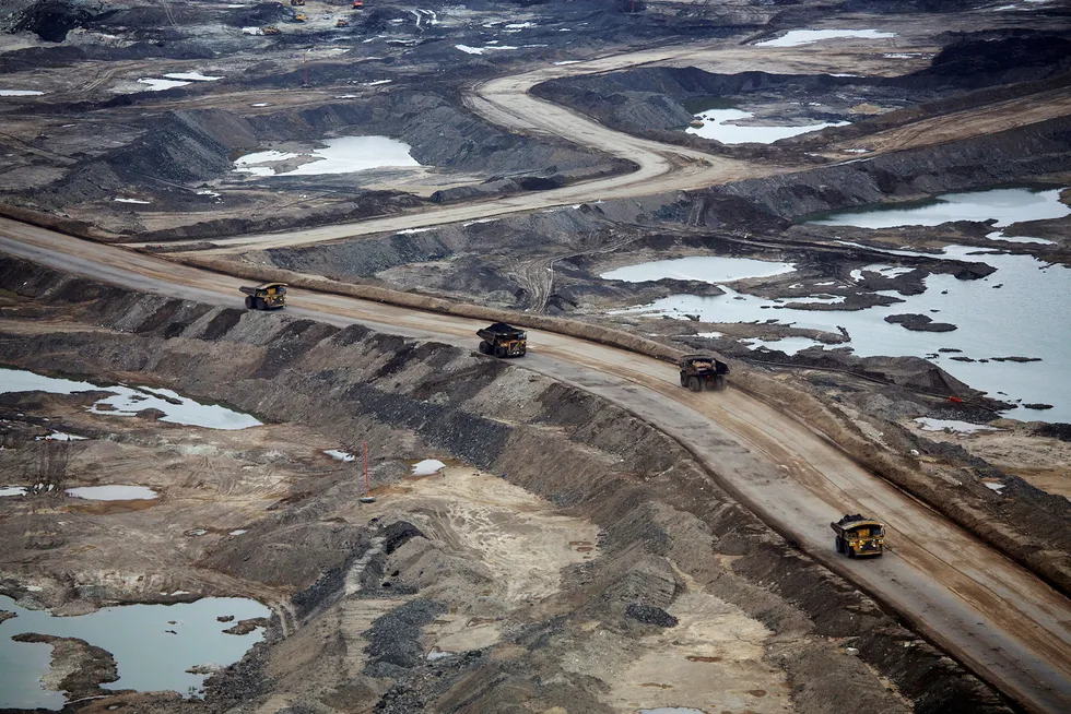 Ambitious clean-up effort: dump trucks hauling raw oil sands at the Suncor oil sands mining operations near Fort McMurray, Alberta, Canada