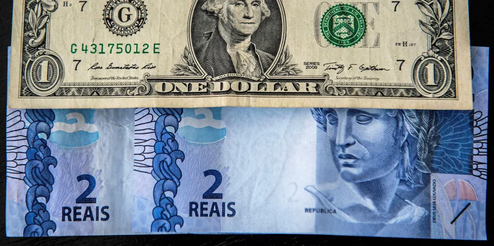 Picture depicting US dollar notes and Brazilian reals.