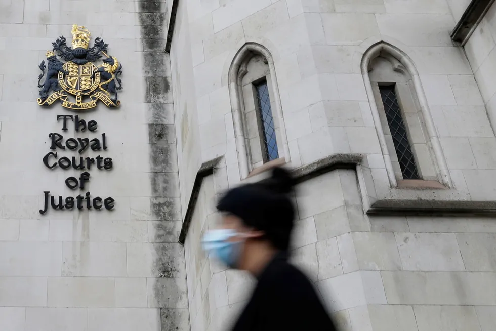 Possible appeal: a pedestrian wears a mask as she passes by the Royal Courts Of Justice, in London, where on Tuesday a judge dismissed a legal challenge against North Sea oil and gas production