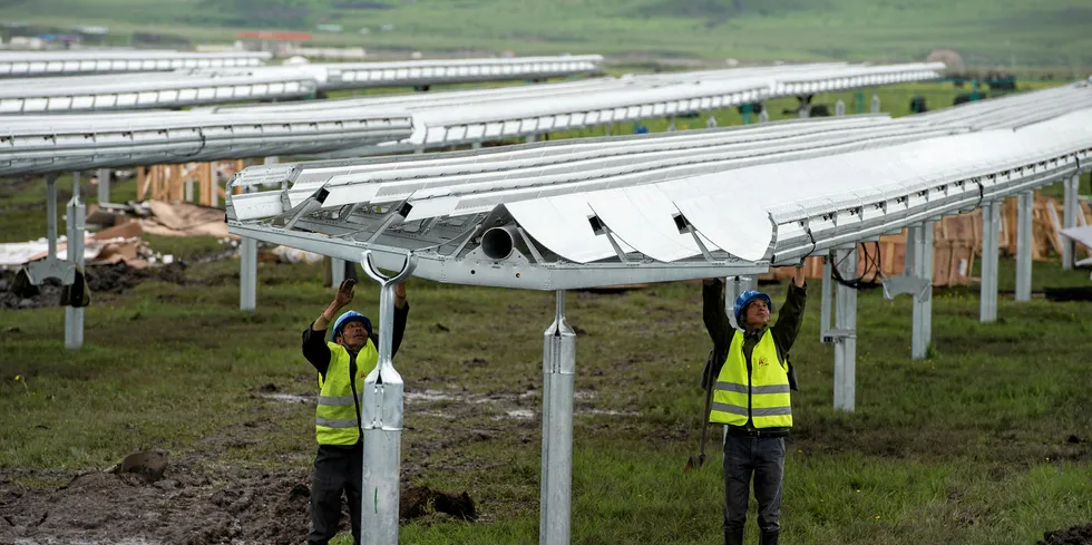 Workers install solar facilities in China