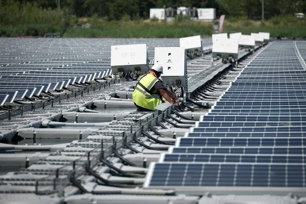 Afloat: a technician works on a photovoltaic solar panel at the O'Mega1 project in France