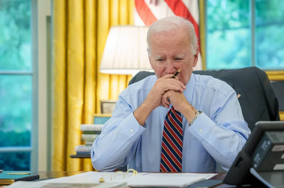 At his desk: US President Joe Biden.