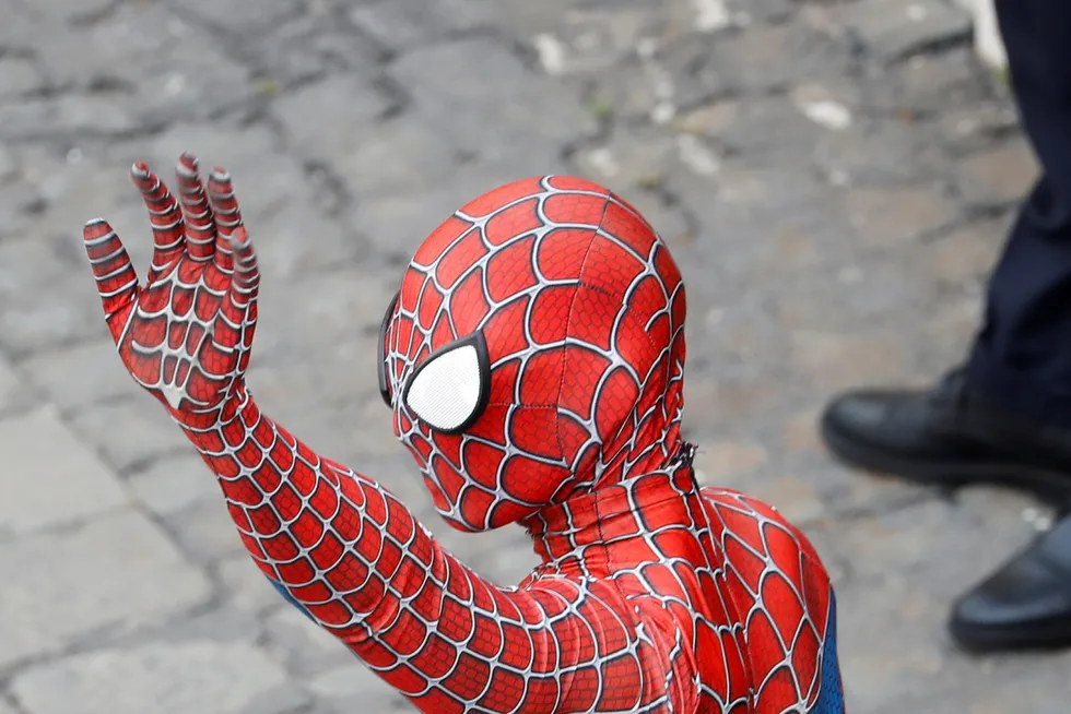 Combatting evil: a person dressed as Spiderman waves in Vatican square, Rome