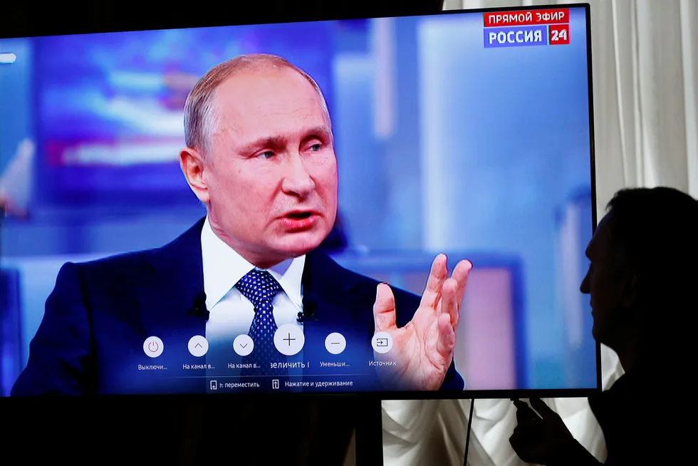 En journalist følger president Vladimir Putins innringerprogram på russisk TV torsdag. Foto: Pavel Golovkin / AP / NTB scanpix