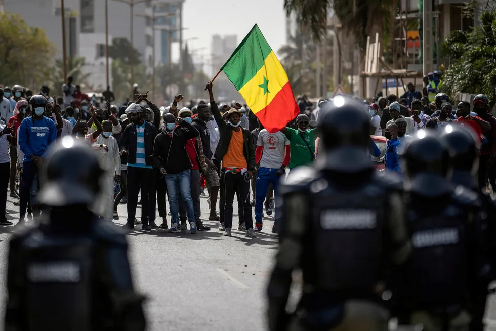 Protest: a demonstrator waves a Senegalese national flag during protests in support of main opposition leader and former presidential candidate Ousmane Sonko in Dakar, Senegal on 3 March