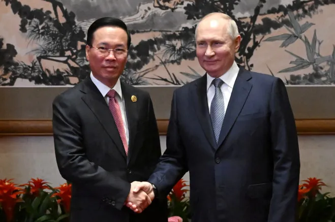 Benefits: Russian President Vladimir Putin (right) shakes hands with Vietnam President Vo Van Thuong.