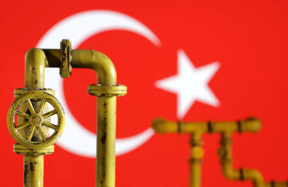 Energy hungry: Model of natural gas pipeline and valves in front of Turkey flag.