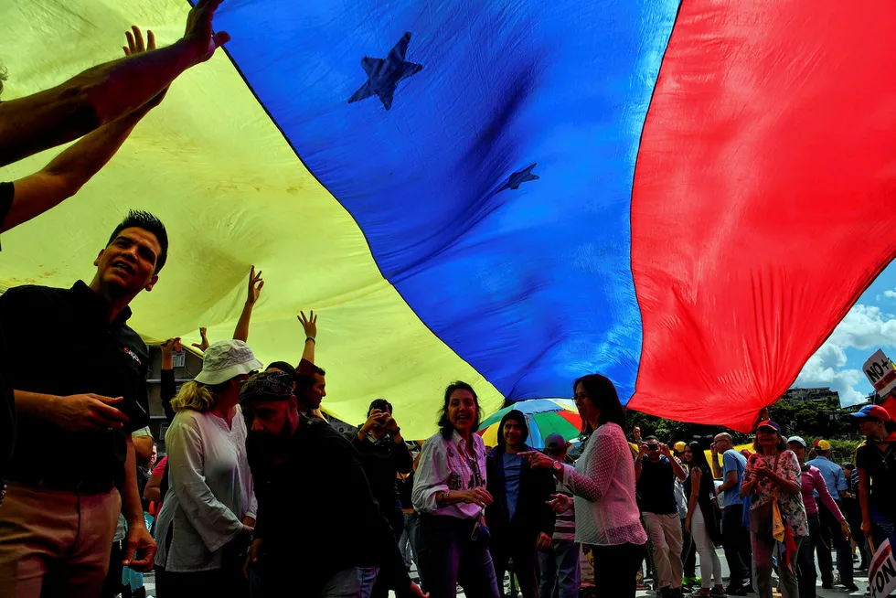Protest: opposition supporters display a Venezuelan national flag during a demonstration against the government of President Nicolas Maduro this week